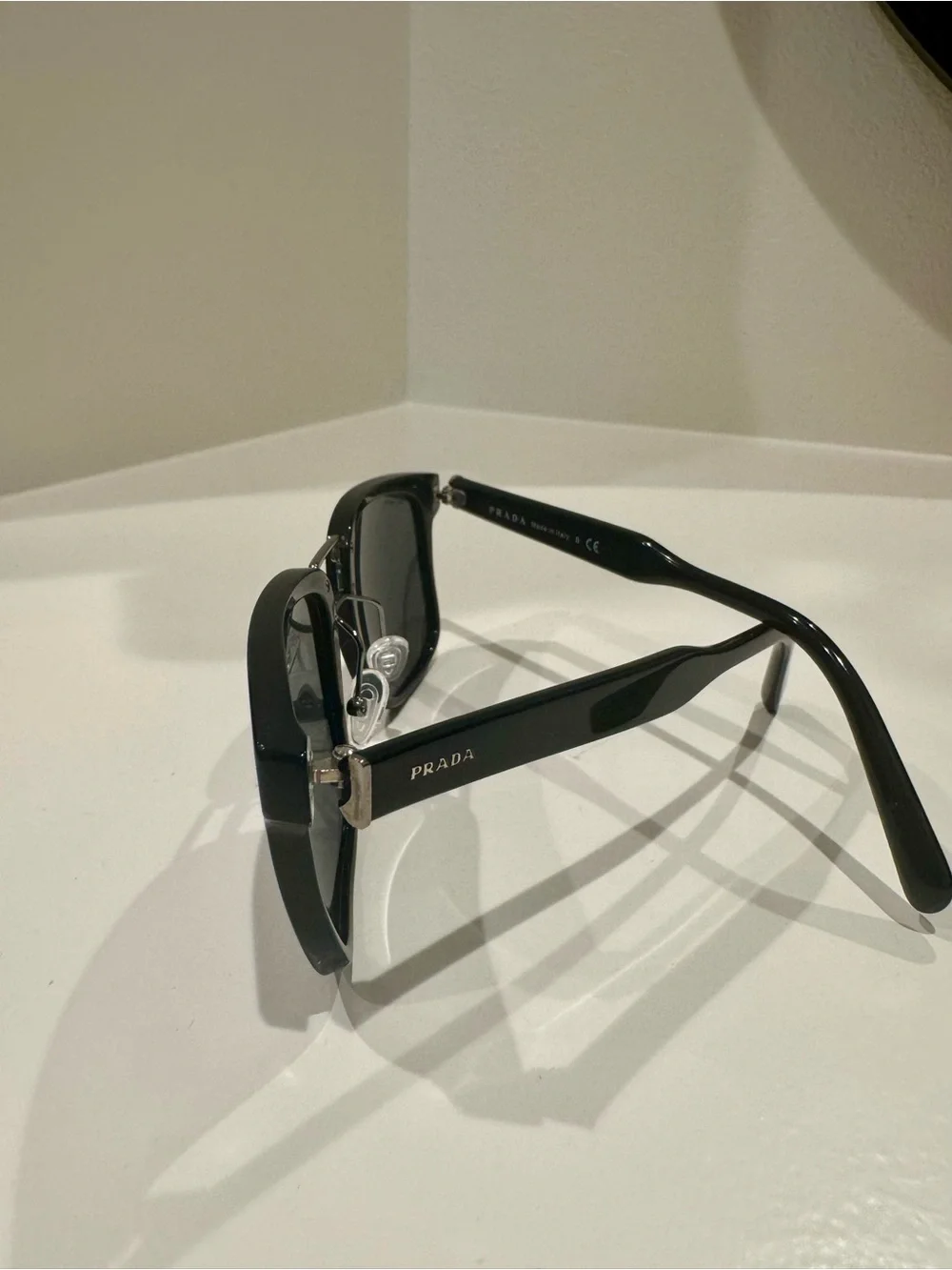 Prada SPR 14T Black unisex sunglasses with silver accents.